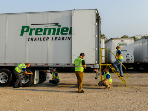 Premier employees inspecting a truck before deployment